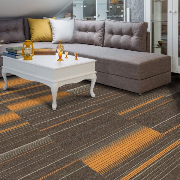 Cozy living room featuring a gray sectional sofa, a white coffee table, and striped orange and gray carpet